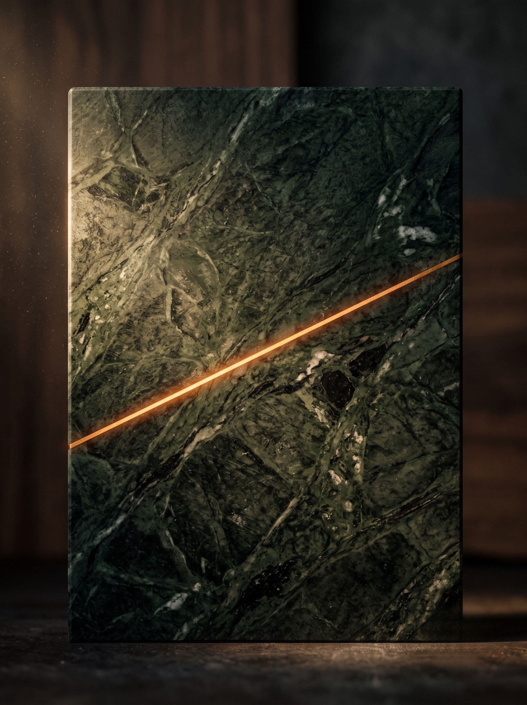 Macro study of dark green marble with a single thin glowing line across its surface